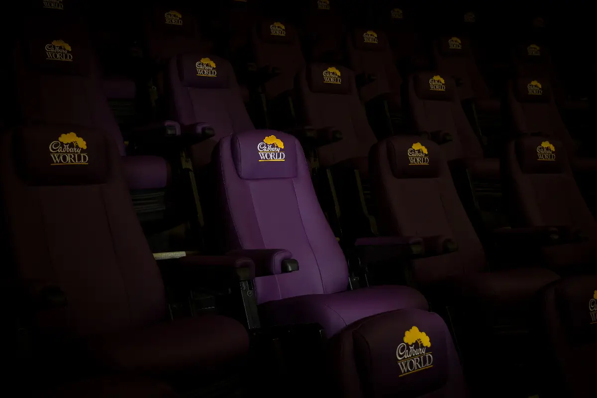 A photo of some dramatically lit Cadbury's World auditorium chairs
